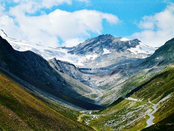 Scenic view of mountains against cloudy sky