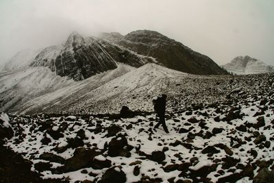 Rear view of person walking on mountain