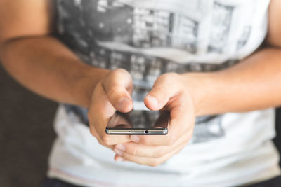 Close-up of man playing using mobile phone