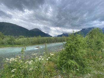 Scenic view of lake by mountains against sky