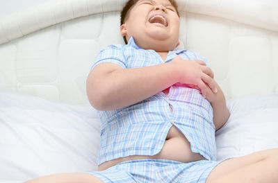 Boy with heart attack sitting on bed at home