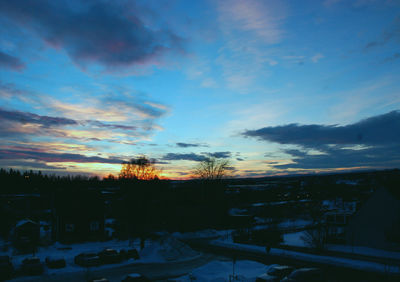 Scenic view of snow covered landscape at sunset