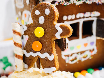 Close-up of gingerbread man and house at home