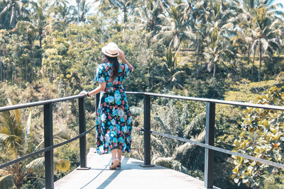 Woman standing on footbridge