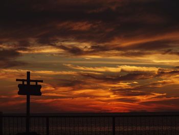 Scenic view of sea against dramatic sky during sunset