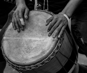 Cropped hands of person playing drum