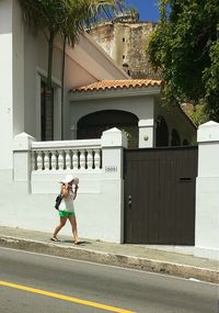 Full length of woman standing in front of building