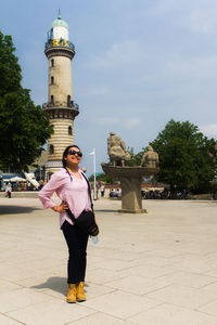 Full length of man standing by historic building against sky