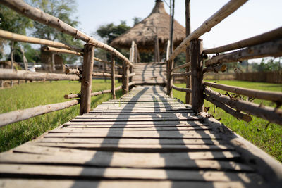 View of wooden footbridge against sky