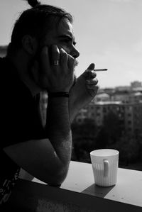 Man drinking glass on table