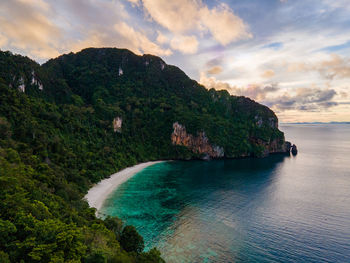 Scenic view of bay against sky at sunset