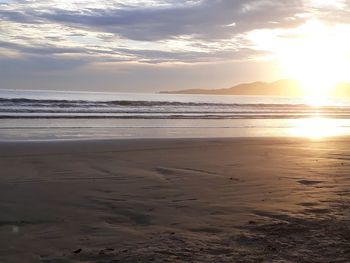 Scenic view of beach against sky during sunset