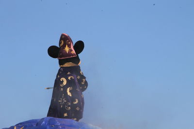 Low angle view of statue against clear blue sky