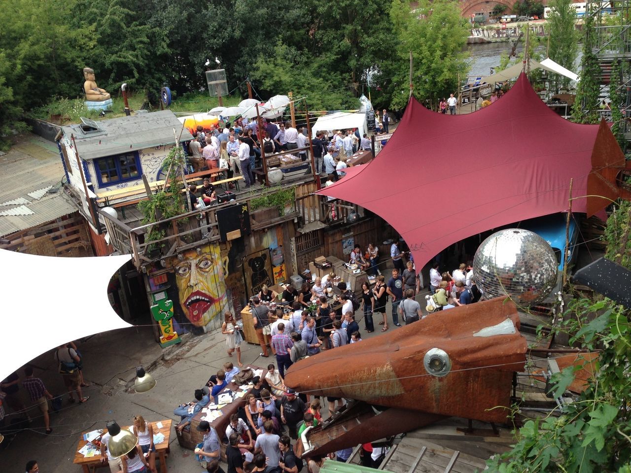 building exterior, architecture, built structure, large group of people, high angle view, street, city, roof, tree, men, cultures, person, outdoors, incidental people, crowded, travel, market, tradition, city life