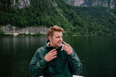 Man looking away against lake