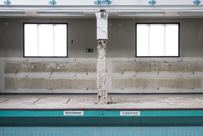 Weathered column at poolside in abandoned building