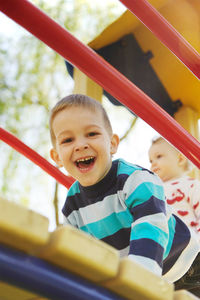 Portrait of happy boy playing in playground