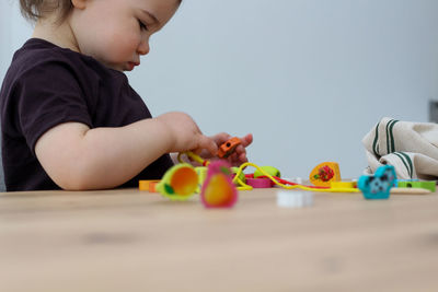 Cute boy playing with toy toys