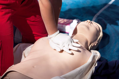 Midsection of woman lying on bed