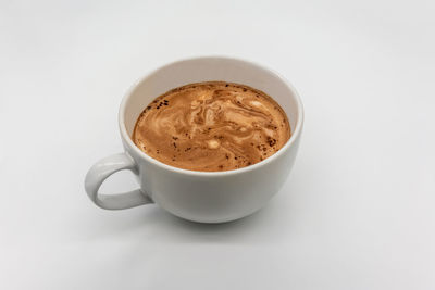 High angle view of coffee cup against white background