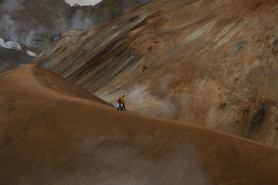 People riding motorcycle on mountain road