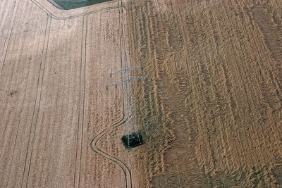 High angle view of tire tracks on field