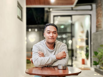 Portrait of mature man on table