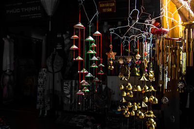 Illuminated lanterns hanging at market stall