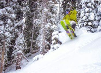 Man skiing on snow covered landscape