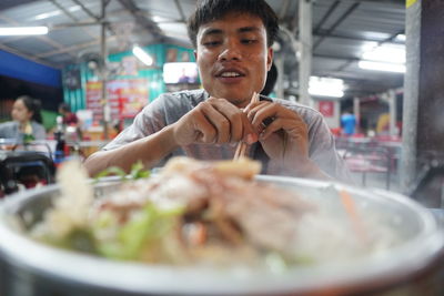 Portrait of man having food in restaurant