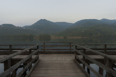 Pier over lake against mountains