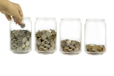 Close-up of hand holding glass against white background