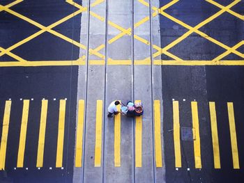 Man pushing luggage cart on zebra crossing