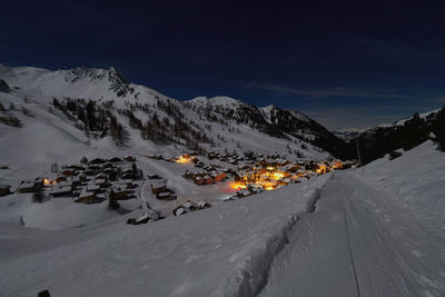 Snowcapped mountains against sky at night