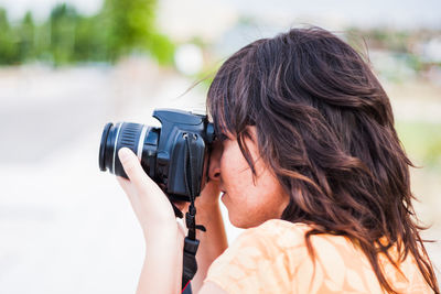 Close-up portrait of woman photographing