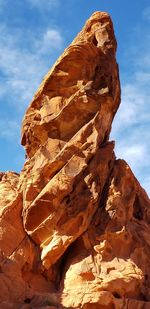 Low angle view of rock formation against sky