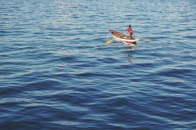 Man paddling in sea