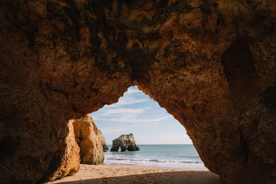 Scenic view of sea seen through cave