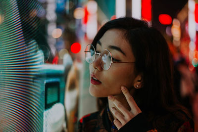 Close-up portrait of young woman looking away