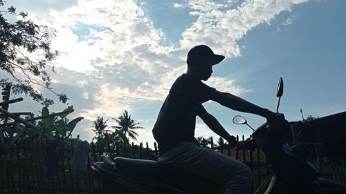 Low angle view of silhouette statue against sky