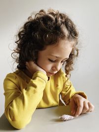 Portrait of cute girl looking on the table 