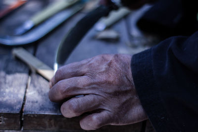 Close-up of man working on table in workshop