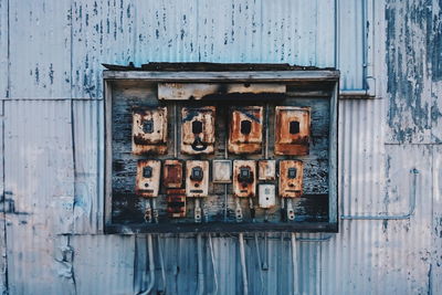 Close-up of electrical boxes on old abandoned building