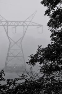 Low angle view of electricity pylon against sky