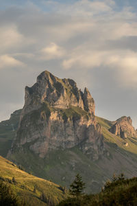 Scenic view of mountains against cloudy sky