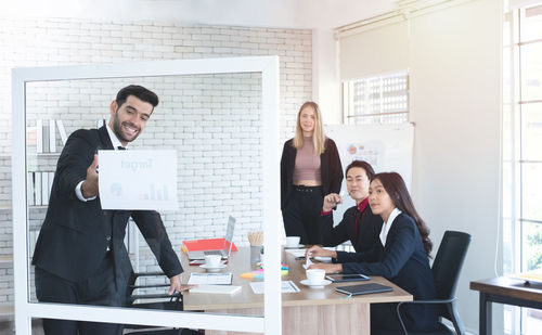 Cheerful businessman giving presentation in office