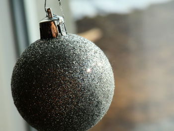 Close-up of crystal ball hanging on metal