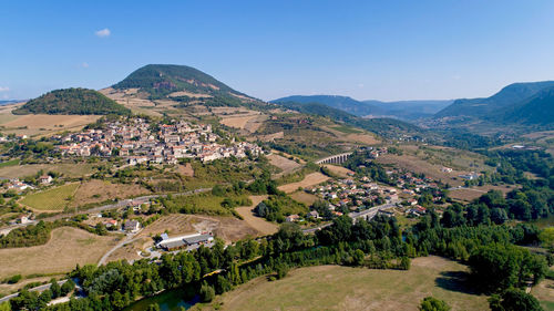 Scenic view of houses and mountains against sky