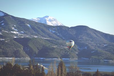 Scenic view of lake and mountains against clear sky