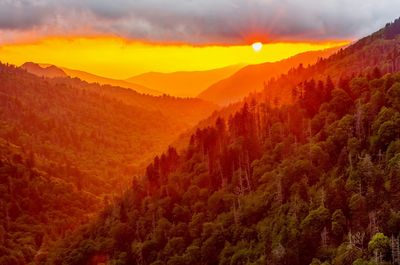 Scenic view of mountains against sky at sunset